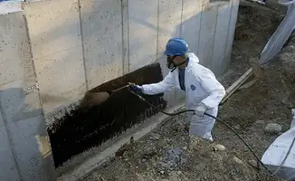 Professional waterproofing the exterior walls of the basement in Tempe, AZ
