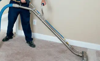 Professional operating a liquid removal machine on a carpeted floor in Tempe, AZ